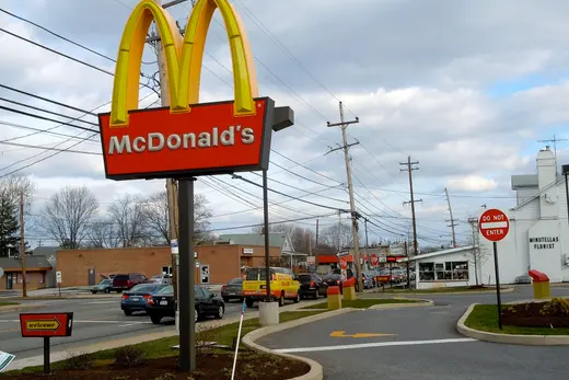 McDonald's sign by a suburban street with cars and buildings., Brookhaven, Pennsylvania