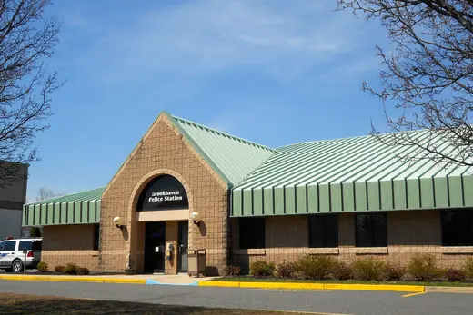 Single-story police station building with green metal roof under blue sky., Brookhaven, Pennsylvania