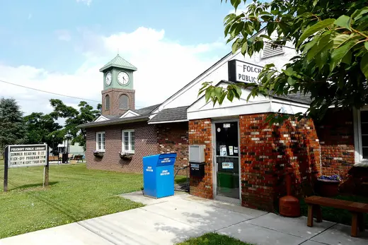 Brick public library building with clock tower and book return bin., Folcroft, Pennsylvania