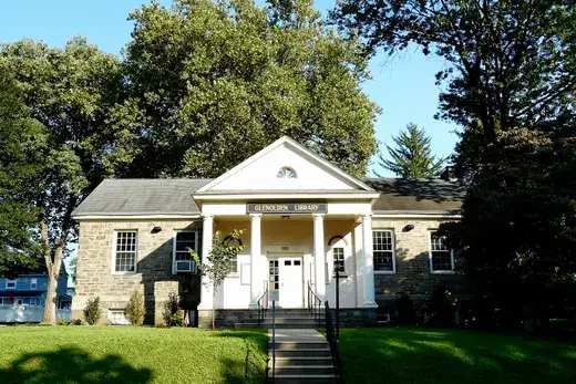 Small stone public library building with front columns and lawn., Glenolden, Pennsylvania
