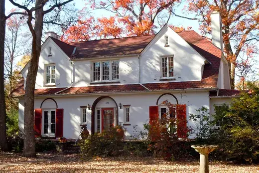 Two-story white house with red shutters and autumn trees, Hatfield Township, Pennsylvania