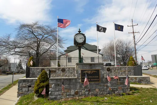 Veterans memorial clock and flags in a small American town square., Lower Chichester Township, Pennsylvania