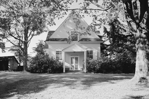 Small white house with trees and front porch in daylight., Merion, Pennsylvania