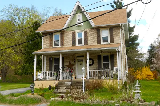 Two-story brick house with front porch and yard., Modena, Pennsylvania