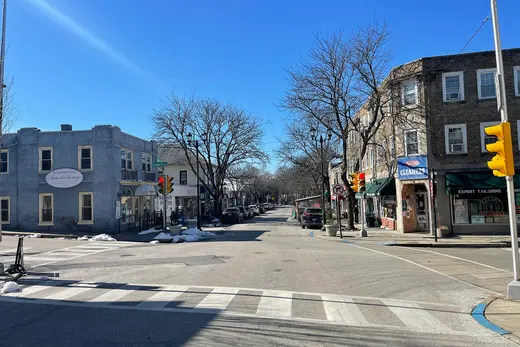 Small-town street intersection with shops, trees, and traffic lights., Narberth, Pennsylvania