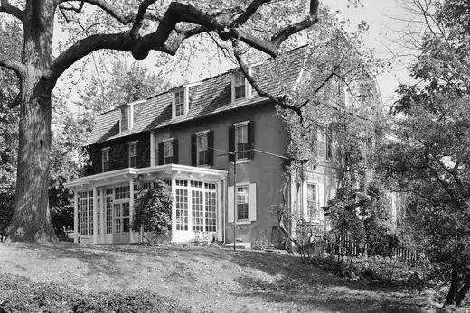 Large historic house with sunroom and big tree in front yard, North Philadelphia, Pennsylvania