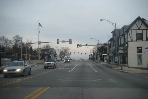 Main street with cars, traffic lights and buildings under overcast sky, Paoli, Pennsylvania