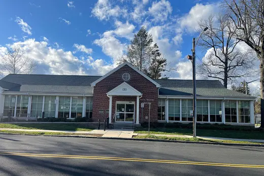 Brick community library building with large windows and blue sky., Penn Wynne, Pennsylvania