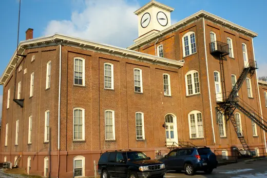 Former Gay Street School building with a clock tower and parked cars., Phoenixville, Pennsylvania