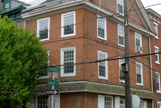 Brick corner building at Front Street with utility pole and street signs, Queen Village, Pennsylvania
