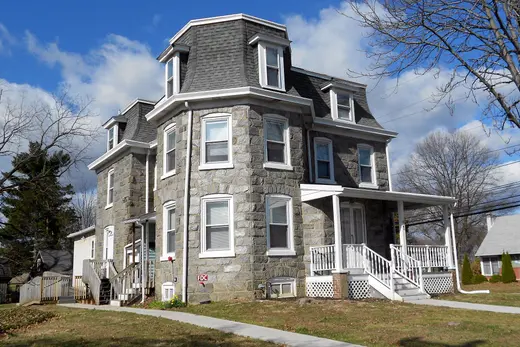 Stone multi-story house with mansard roof and front porch., Rutledge, Pennsylvania
