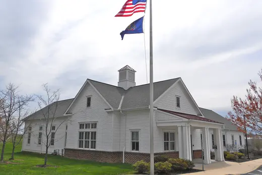 White suburban public building with American flag on a flagpole., Sadsbury Township, Pennsylvania