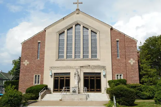 Brick church with steps, statue, and large stained-glass window., Sharon Hill, Pennsylvania