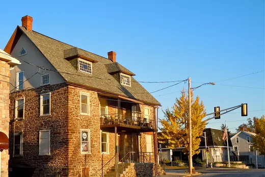 Stone commercial/residential building on a small town street at sunset, Souderton, Pennsylvania