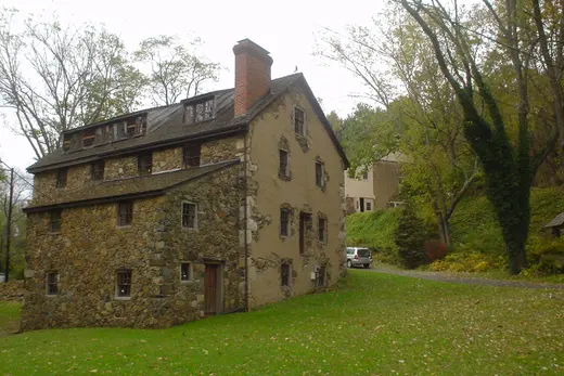 Stone historic house beside a grassy lawn and trees, Thornbury Township, Pennsylvania
