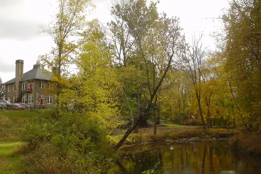 Autumn park with a pond and a stone building beside the trees., Thornbury Township, Pennsylvania