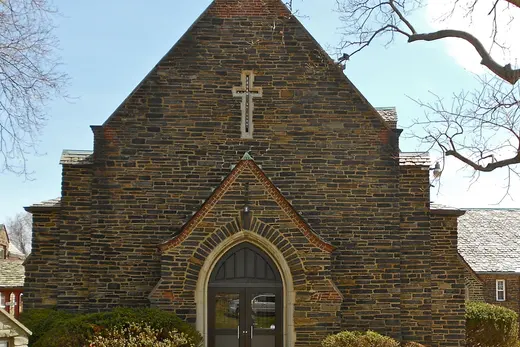 Front entrance of a stone church with cross and pathway, Trainer, Pennsylvania