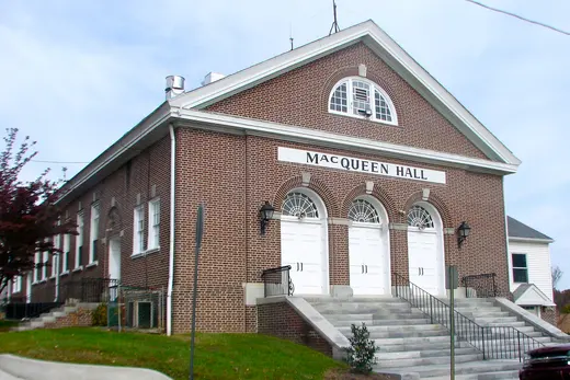 Brick building named MacQueen Hall with steps and three arched doors., Upland, Pennsylvania
