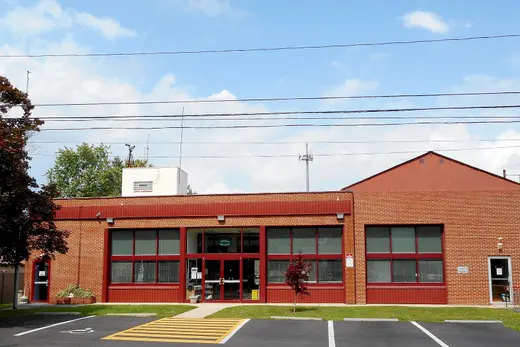 Brick municipal building with parking lot and crosswalk in front, Upper Darby, Pennsylvania