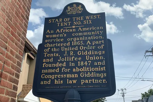 Historic marker sign on a sidewalk beside a residential street, West Chester, Pennsylvania