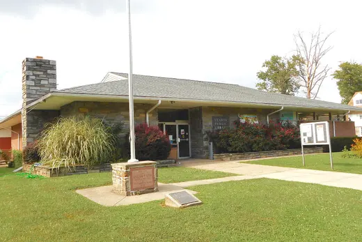 Low stone public library building with flagpole and lawn, Yeadon, Pennsylvania